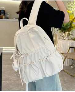 White pleated backpack with bow and pockets, casual lightweight school bag for students travel.