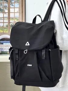 Close-up detail of the black Japanese style casual backpack, highlighting strap and flap design.