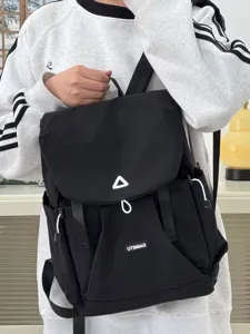 Casual black backpack detail, lightweight daily commuter school bag with front pocket design.