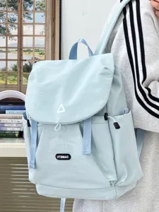 Lightweight casual backpack detail, stylish light blue daily commuter bag for women and students.