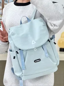 Detailed shot of light blue casual backpack featuring flap cover, front pocket and straps.