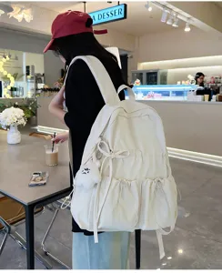 Casual white backpack with cute bow and multi-pockets, perfect for school and daily travel.