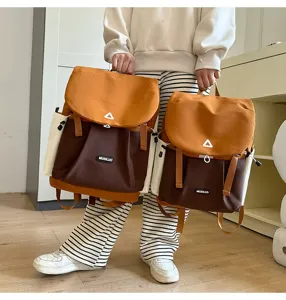 Casual color-block backpack detailed view showing durable canvas material and front pockets.