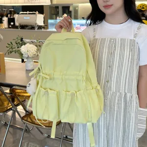 Lightweight pleated backpack for women and teens, cute bow travel school bag with multi pockets.