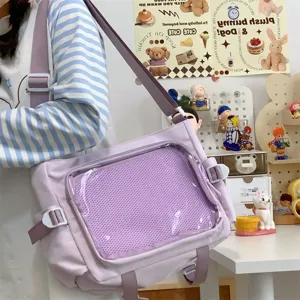 Detailed view of cute purple ita bag with clear mesh front pocket and shoulder strap.