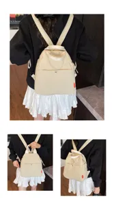 Detail view of a versatile beige canvas backpack with casual design for daily commute.