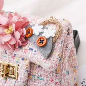 Pink tweed girls shoulder bag detail featuring floral decor and cute felt accessory.