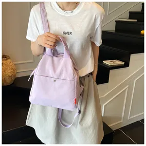 Detailed view of the purple casual backpack, showing fabric texture and front pocket.