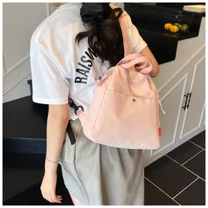 Casual pink multi-functional backpack for women, stylish minimalist commuting travel bag.