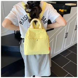 Yellow casual mini backpack detail, minimalist canvas school bag for daily commute.
