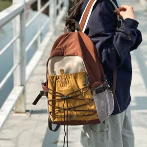 Casual outdoor travel backpack, lightweight hiking daypack with drawstring and mesh pockets.