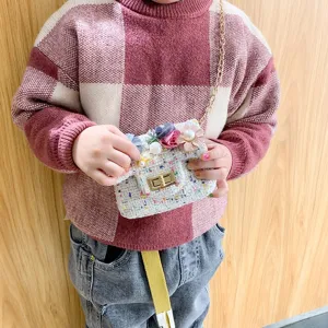 Kids tweed crossbody bag featuring floral pearl embellishments and chic gold chain strap design.