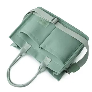 Light green canvas shoulder messenger bag commuter casual tote bag with double pockets.