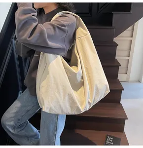 Large capacity canvas tote bag for women, simple solid color shoulder handbag for daily commute.