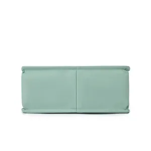 Detailed view of the light green canvas bag bottom, showing neat stitching and fabric texture.