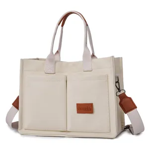Canvas tote bag with brown leather handles, casual shoulder bag for women daily commuting.