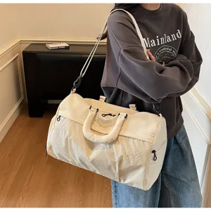 Large capacity travel gym bag for women, stylish lightweight shoulder duffel bag.