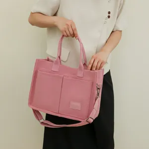 Pink felt tote bag with multi pockets and shoulder strap for women daily commute style.