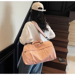 Pink large capacity travel gym duffel bag for women, stylish lightweight shoulder bag.