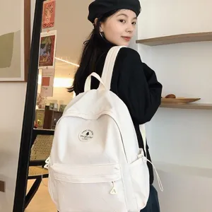 Mochila de lona blanca minimalista para mujer y estudiantes, gran capacidad, bolso casual elegante.