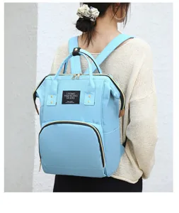 Sac à dos à langer bleu clair multifonctionnel, grande capacité pour voyage et usage quotidien.