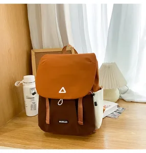 Detailed shot of the casual color-block backpack scene, featuring soft textures and cozy desk props.
