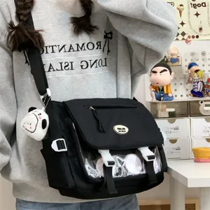 Detail shot of cute student messenger bag with clear window for pins and large storage.
