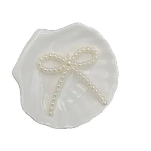 Pearl bow DIY pendant charm, hanging hole beaded accessory for phone chains and bracelets.