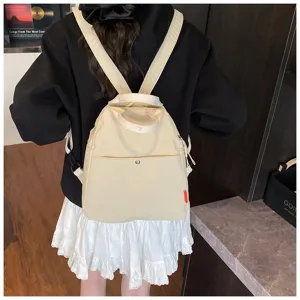 Close-up detail view of the beige canvas casual backpack, highlighting strap and pocket.