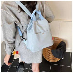 Light blue casual backpack detail showcasing minimalist design, versatile daily commuter bag.