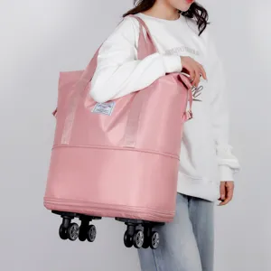 Large capacity pink travel duffel bag with spinner wheels and expandable bottom layer design.