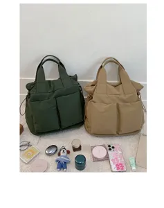 Nylon tote bag scene highlighting large capacity, dual handles, and useful front pockets.
