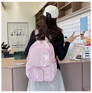 Pink Ita backpack with clear front pockets and star prints, shown in a bright lifestyle store.