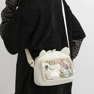 Cute white ita bag with cat ears and transparent window for anime badges and plush accessories.