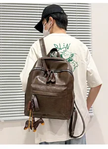 Detailed view of vintage PU leather backpack with crocodile texture pocket and cute dog charm.