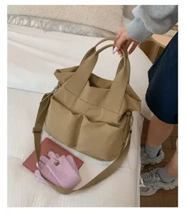 Casual nylon tote bag for women, large capacity shoulder bag with multiple front pockets.