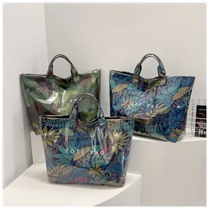 Detail shot of waterproof PVC tote bag with botanical leaf print, casual large capacity handbag.
