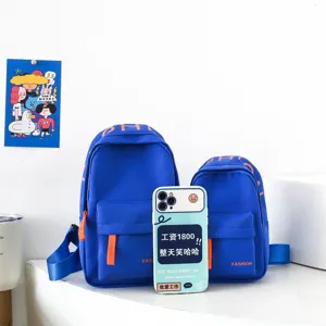 Detailed view of trendy kids blue chest bag with orange accents, stylish boys shoulder backpack.