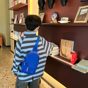 Kids blue crossbody chest bag, stylish casual canvas shoulder bag for boys daily streetwear outfit.