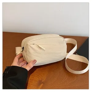Closeup view of the casual nylon crossbody bag showcasing durable fabric and smooth zippers.