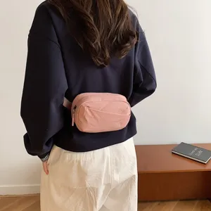 Stylish pink nylon waist bag for women, casual chest bag and crossbody bag for outdoor travel.