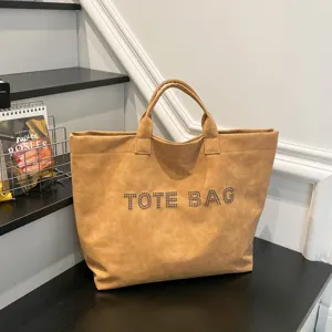 Large capacity brown tote bag with studded letters, stylish shoulder bag for women daily commute.