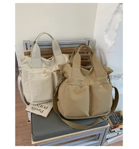 Casual nylon tote bag in neutral tones, featuring large capacity and dual outer pockets.