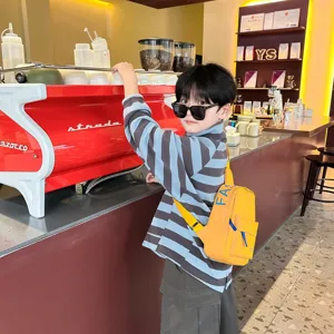 Detailed view of trendy kids chest bag, stylish yellow crossbody bag for boys street fashion.