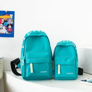 Detailed close-up of stylish teal children chest bags featuring front pockets and fashion print.