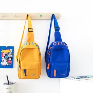 Kids chest bag detail view, trendy single shoulder canvas messenger bag in vibrant yellow and blue.