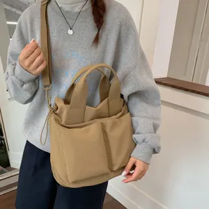 Casual nylon tote bag for women, large capacity shoulder and crossbody bag for daily commute.