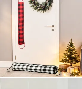 Christmas door draft stopper scene detail, black and white plaid fabric door seal decor.