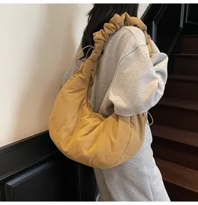 Detailed view of casual nylon cloud dumpling shoulder bag with stylish ruffled strap.