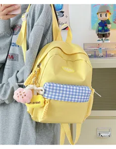 Cute yellow mini backpack for women, canvas casual school bookbag with cute plush pendants.